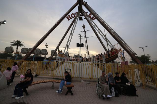 People visit an amusement park in the Mansour district of Baghdad on May 28, 2026 on the second day of Eid al-Adha, the Feast of Sacrifice, which marks the end of the annual Hajj pilgrimage to Mecca and commemorates the Prophet Abraham's willingness to sacrifice his son in obedience to God. (Photo by AHMAD AL-RUBAYE / AFP)