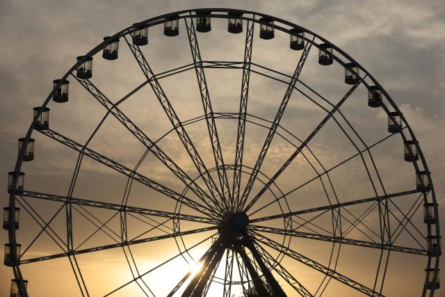 People ride a Ferris wheel at an amusement park in the Mansour district of Baghdad on May 28, 2026 on the second day of Eid al-Adha, the Feast of Sacrifice, which marks the end of the annual Hajj pilgrimage to Mecca and commemorates the Prophet Abraham's willingness to sacrifice his son in obedience to God. (Photo by AHMAD AL-RUBAYE / AFP)