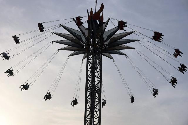 People sit in a ride at an amusement park in the Mansour district of Baghdad on May 28, 2026 on the second day of Eid al-Adha, the Feast of Sacrifice, which marks the end of the annual Hajj pilgrimage to Mecca and commemorates the Prophet Abraham's willingness to sacrifice his son in obedience to God. (Photo by AHMAD AL-RUBAYE / AFP)