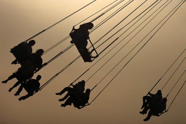 People sit in a ride at an amusement park in the Mansour district of Baghdad on May 28, 2026 on the second day of Eid al-Adha, the Feast of Sacrifice, which marks the end of the annual Hajj pilgrimage to Mecca and commemorates the Prophet Abraham's willingness to sacrifice his son in obedience to God. (Photo by AHMAD AL-RUBAYE / AFP)