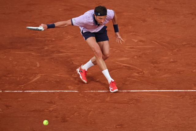 France's Arthur Rinderknech plays a backhand return to Italy's Matteo Berrettini during their men's singles match on day 5 of the French Open tennis tournament on Court Philippe-Chatrier at the Roland-Garros Complex in Paris on May 28, 2026. (Photo by Anne-Christine POUJOULAT / AFP)