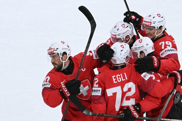 Switzerland's defender #90 Roman Josi (L) celebrates scoring his team's first goal during the IIHF Ice Hockey Men's World Championship quarter-final match between Switzerland and Sweden at the Swiss Life Arena in Zurich, on May 28, 2026. (Photo by SEBASTIEN BOZON / AFP)
