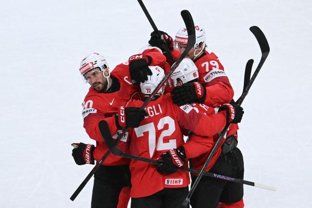 Switzerland's defender #90 Roman Josi (L) celebrates scoring his team's first goal during the IIHF Ice Hockey Men's World Championship quarter-final match between Switzerland and Sweden at the Swiss Life Arena in Zurich, on May 28, 2026. (Photo by SEBASTIEN BOZON / AFP)