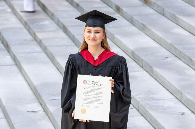 This photo taken on May 27, 2026 shows Princess Elisabeth of Belgium posing in her cap and gown and holding her diploma at Harvard Yard at Harvard University in Cambridge, Massachusetts. Princess Elisabeth, the heir apparent to the Belgian throne, is graduating with a Master's degree in Public Policy from Harvard Kennedy School. (Photo by Joseph Prezioso / AFP)