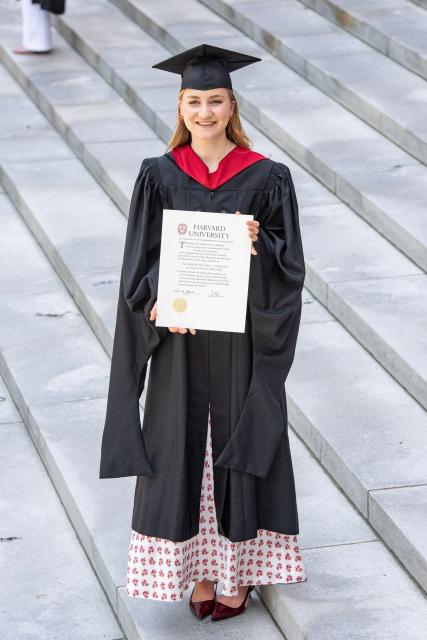 This photo taken on May 27, 2026 shows Princess Elisabeth of Belgium posing in her cap and gown and holding her diploma at Harvard Yard at Harvard University in Cambridge, Massachusetts. Princess Elisabeth, the heir apparent to the Belgian throne, is graduating with a Master's degree in Public Policy from Harvard Kennedy School. (Photo by Joseph Prezioso / AFP)