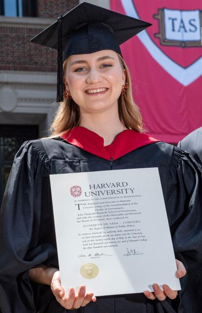 This photo taken on May 27, 2026 shows Princess Elisabeth of Belgium posing in her cap and gown and holding her diploma at Harvard Yard at Harvard University in Cambridge, Massachusetts. Princess Elisabeth, the heir apparent to the Belgian throne, is graduating with a Master's degree in Public Policy from Harvard Kennedy School. (Photo by Joseph Prezioso / AFP)