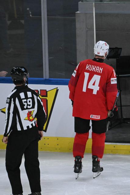 Switzerland's defender #14 Dean Kukan leaves after he was sent off during the IIHF Ice Hockey Men's World Championship quarter-final match between Switzerland and Sweden at the Swiss Life Arena in Zurich, on May 28, 2026. (Photo by SEBASTIEN BOZON / AFP)
