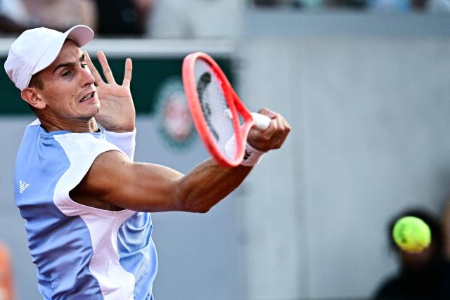 Italy's Matteo Arnaldi plays a forehand return to Greece's Stefanos Tsitsipas during their men's singles match on day 5 of the French Open tennis tournament at the Roland-Garros Complex in Paris on May 28, 2026. (Photo by JULIEN DE ROSA / AFP)