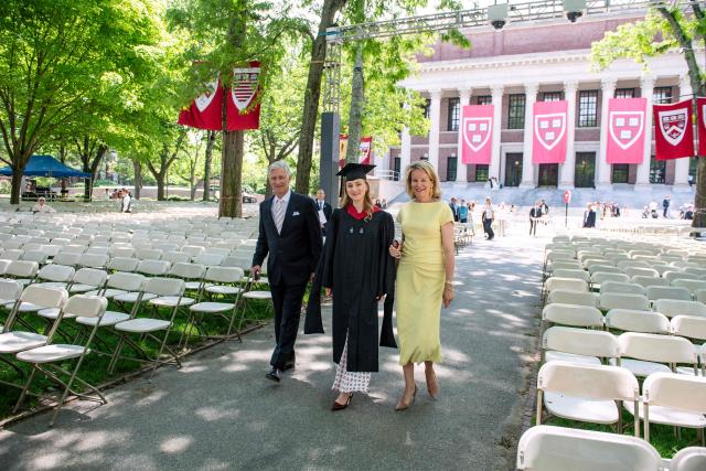 This photo taken on May 27, 2026 shows Princess Elisabeth of Belgium walking in her cap and gown next to her parents King Philippe and Queen Mathilde at Harvard Yard at Harvard University in Cambridge, Massachusetts. Princess Elisabeth, the heir apparent to the Belgian throne, is graduating with a Master's degree in Public Policy from Harvard Kennedy School. (Photo by Joseph Prezioso / AFP)