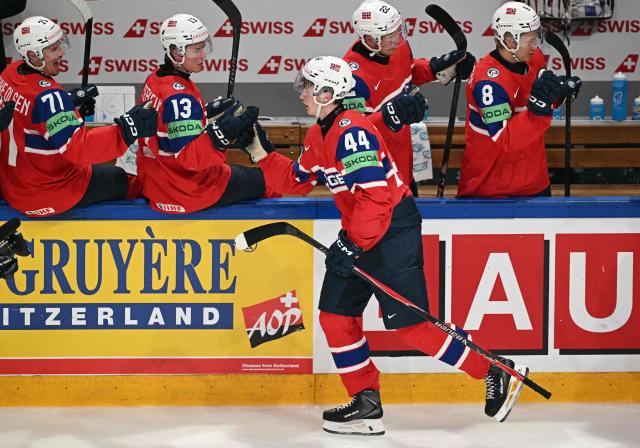 Norway's forward #44 Tinus Luc Koblar celebrates scoring his team's first goal with teammates during the IIHF Ice Hockey Men's World Championship quarter-final match between Norway and Latvia in Fribourg, Switzerland on May 28, 2026. (Photo by Fabrice COFFRINI / AFP)