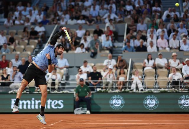 Italy's Matteo Berrettini serves to France's Arthur Rinderknech during their men's singles match on day 5 of the French Open tennis tournament on Court Philippe-Chatrier at the Roland-Garros Complex in Paris on May 28, 2026. (Photo by Anne-Christine POUJOULAT / AFP)