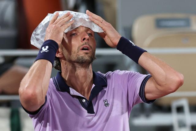 France's Arthur Rinderknech cools down during a break in play in his men's singles match against Italy's Matteo Berrettini on day 5 of the French Open tennis tournament on Court Philippe-Chatrier at the Roland-Garros Complex in Paris on May 28, 2026. (Photo by Anne-Christine POUJOULAT / AFP)