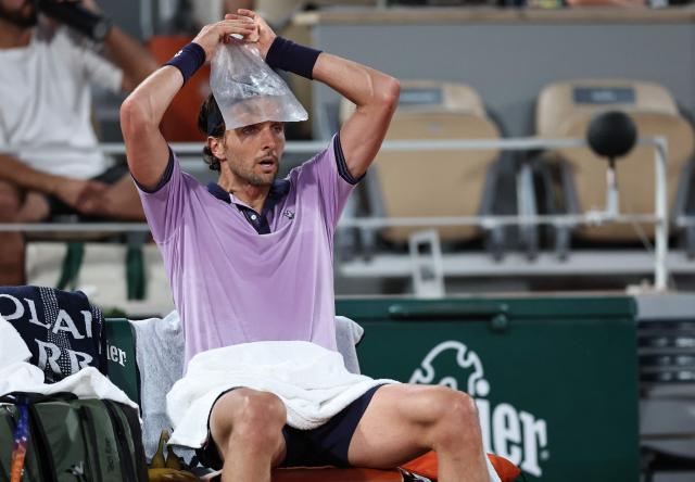 France's Arthur Rinderknech cools down during a break in play in his men's singles match against Italy's Matteo Berrettini on day 5 of the French Open tennis tournament on Court Philippe-Chatrier at the Roland-Garros Complex in Paris on May 28, 2026. (Photo by Anne-Christine POUJOULAT / AFP)