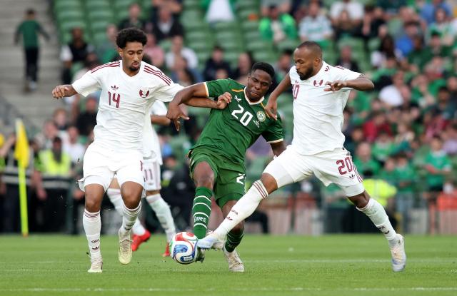 Republic of Ireland's midfielder Chiedozie Ogbene is put under pressure by Qatar's Defender #14 Homam El Amin (L) and Qatar's Midfielder #20 Ahmed Fathy (R) during the international friendly football match between the Republic of Ireland and Qatar, at the Aviva Stadium in Dublin, Ireland on May 28, 2026. (Photo by Paul Faith / AFP)