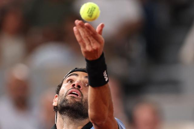 Italy's Matteo Berrettini serves to France's Arthur Rinderknech during their men's singles match on day 5 of the French Open tennis tournament on Court Philippe-Chatrier at the Roland-Garros Complex in Paris on May 28, 2026. (Photo by Anne-Christine POUJOULAT / AFP)