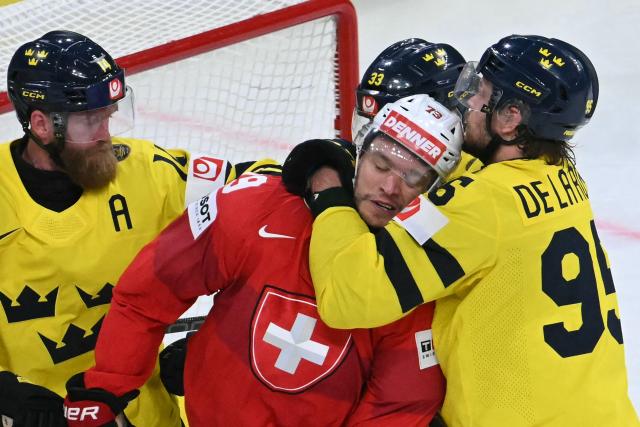Switzerland's forward #79 Calvin Thurkauf (2C) and Sweden's forward #95 Jacob de la Rose (R) scuffle during the IIHF Ice Hockey Men's World Championship quarter-final match between Switzerland and Sweden at the Swiss Life Arena in Zurich, on May 28, 2026. (Photo by SEBASTIEN BOZON / AFP)