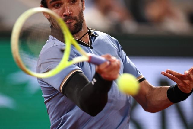 Italy's Matteo Berrettini plays a forehand return to France's Arthur Rinderknech during their men's singles match on day 5 of the French Open tennis tournament on Court Philippe-Chatrier at the Roland-Garros Complex in Paris on May 28, 2026. (Photo by Anne-Christine POUJOULAT / AFP)