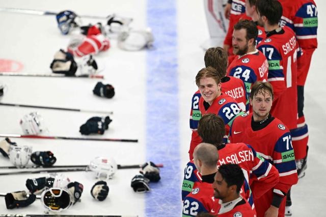 Norway's players celebrate winning the IIHF Ice Hockey Men's World Championship quarter-final match between Norway and Latvia in Fribourg, Switzerland on May 28, 2026. Norway won the match 2-0. (Photo by Fabrice COFFRINI / AFP)