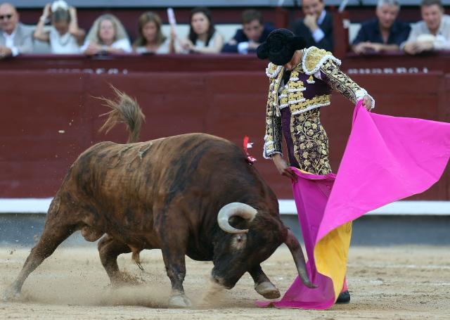 Peruvian bullfighter Andres Roca Rey performs a pass to a bull during the San Isidro Fair at Las Ventas bullring in Madrid on May 28, 2026. (Photo by ALBERTO SIMON / AFP)