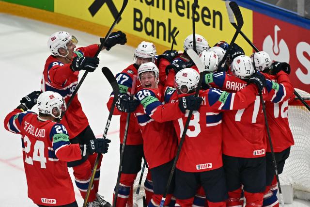 Norway's players celebrate winning the IIHF Ice Hockey Men's World Championship quarter-final match between Norway and Latvia in Fribourg, Switzerland on May 28, 2026. Norway won the match 2-0. (Photo by Fabrice COFFRINI / AFP)
