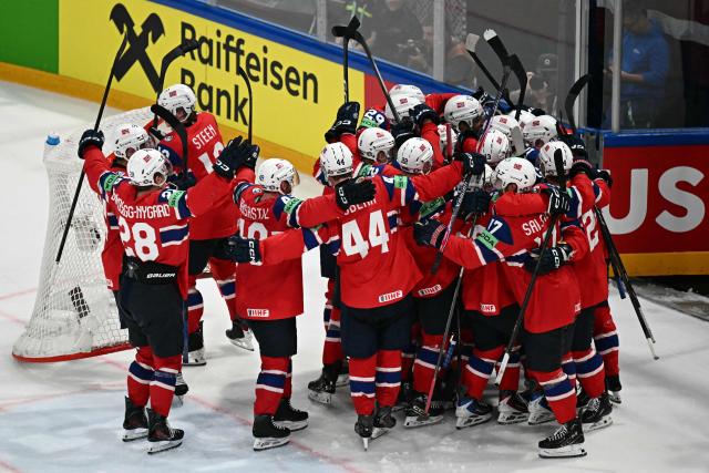 Norway's players celebrate winning the IIHF Ice Hockey Men's World Championship quarter-final match between Norway and Latvia in Fribourg, Switzerland on May 28, 2026. Norway won the match 2-0. (Photo by Fabrice COFFRINI / AFP)