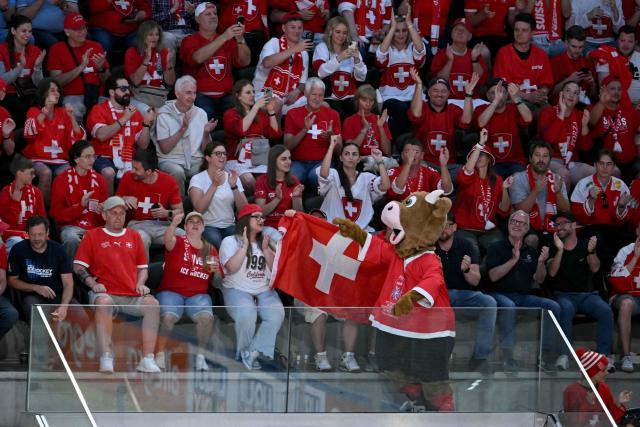 The mascot Cooly and supporters cheer during the IIHF Ice Hockey Men's World Championship quarter-final match between Switzerland and Sweden at the Swiss Life Arena in Zurich, on May 28, 2026. (Photo by SEBASTIEN BOZON / AFP)