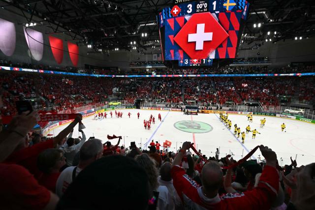 Switzerland's supporters cheer after winning the IIHF Ice Hockey Men's World Championship quarter-final match between Switzerland and Sweden at the Swiss Life Arena in Zurich, on May 28, 2026. (Photo by SEBASTIEN BOZON / AFP)