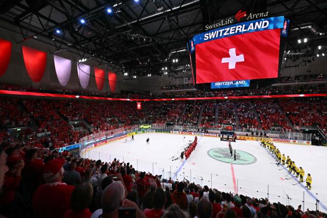 The scoreboard shows Switzerland's flag after winning the IIHF Ice Hockey Men's World Championship quarter-final match between Switzerland and Sweden at the Swiss Life Arena in Zurich, on May 28, 2026. (Photo by SEBASTIEN BOZON / AFP)