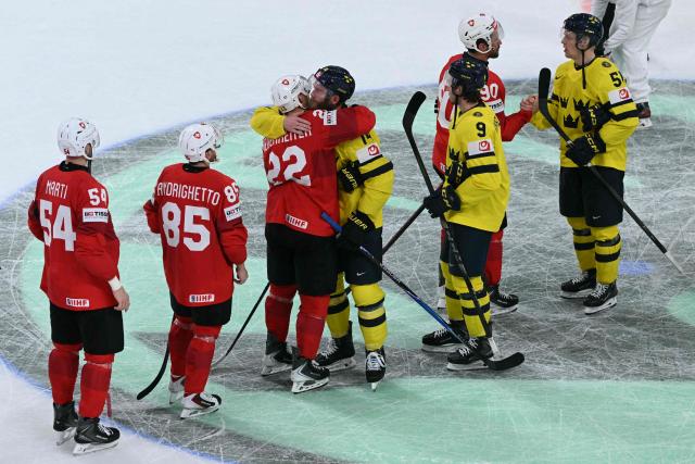 Sweden's players congratulate Switzerland's players at the end of the IIHF Ice Hockey Men's World Championship quarter-final match between Switzerland and Sweden at the Swiss Life Arena in Zurich, on May 28, 2026. (Photo by SEBASTIEN BOZON / AFP)