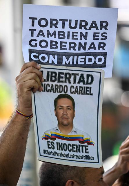 A relative of a political prisoner protests outside the Public Prosecutor’s Office in Caracas on May 28, 2026, calling for the release of their loved one. (Photo by Juan BARRETO / AFP)