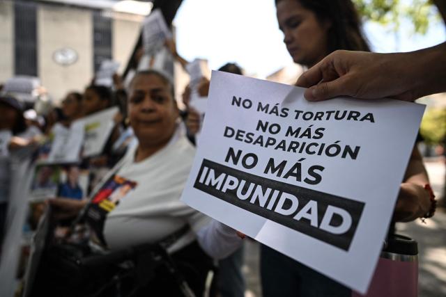 Relatives of political prisoners protest outside the Public Prosecutor's Office in Caracas on May 28, 2026, calling for the release of their loved ones. (Photo by Juan BARRETO / AFP)