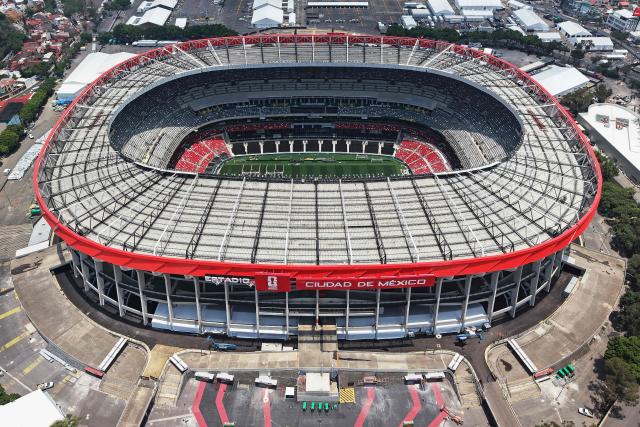 This aerial view shows the Mexico City Stadium, renamed from Azteca Stadium (or Banorte Stadium) for the FIFA World Cup, in Mexico City on May 28, 2026. FIFA temporarily branded the iconic Azteca Stadium as "Mexico City Stadium" for the 2026 World Cup, enforcing a strict "debranding" policy that requires all host stadiums to remove or cover non-official corporate sponsor names, suite branding, and external logos. (Photo by Carl DE SOUZA / AFP)