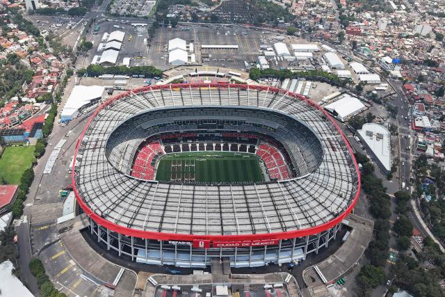 This aerial view shows the Mexico City Stadium, renamed from Azteca Stadium (or Banorte Stadium) for the FIFA World Cup, in Mexico City on May 28, 2026. FIFA temporarily branded the iconic Azteca Stadium as "Mexico City Stadium" for the 2026 World Cup, enforcing a strict "debranding" policy that requires all host stadiums to remove or cover non-official corporate sponsor names, suite branding, and external logos. (Photo by Carl DE SOUZA / AFP)