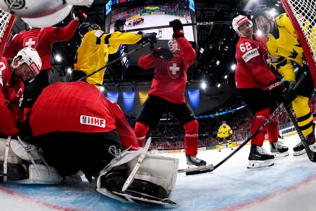 (From L) Switzerland's defender #90 Roman Josi, Switzerland's goalkeeper #63 Leonardo Genoni, Switzerland's forward #13 Nico Hischier, Sweden's forward #15 Jack Berglund, Switzerland's defender #86 Janis Moser, Switzerland's forward #62 Denis Malgin and Sweden's forward #61 Viggo Bjork fight for the puck during the IIHF Ice Hockey Men's World Championship quarter-final match between Switzerland and Sweden at the Swiss Life Arena in Zurich, on May 28, 2026. (Photo by CLAUDIO THOMA / POOL / AFP)