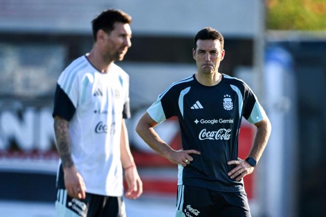 (FILES) Argentina's head coach Lionel Scaloni (R) looks at forward Lionel Messi during a training session in Ezeiza, Buenos Aires province, Argentina, on March 30, 2026, ahead of a friendly match against Zambia on March 31 at the La Bombonera Stadium in Buenos Aires. Lionel Messi will captain Argentina at the World Cup, national head coach Lionel Scaloni announced on May 28, 2026, as he unveiled his 26-man squad. Messi, 38, heads the list on his sixth World Cup appearance, which notably omits Real Madrid's Franco Mastantuono. (Photo by Luis ROBAYO / AFP)