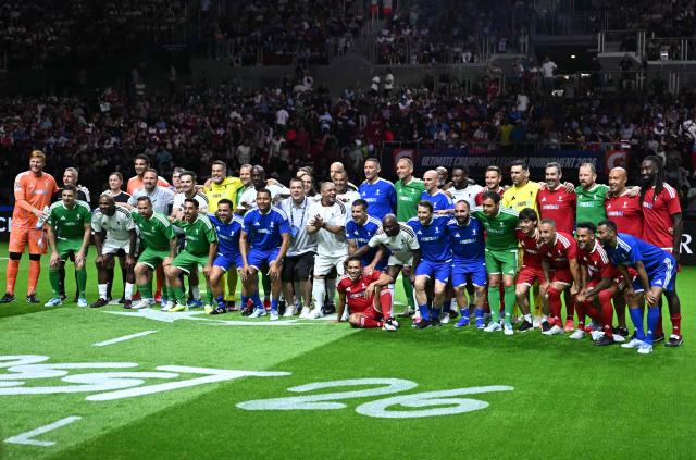 Players pose for a family photo prior to the Ultimate Champions Legends Tournament on May 29, 2026, at the Papp Laszlo Arena in Budapest, Hungary, on the eve of the UEFA Champions League final. (Photo by Attila KISBENEDEK / AFP)