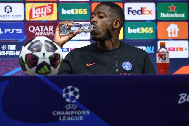 Paris Saint-Germain's French forward #10 Ousmane Dembele takes a sip of water at the start of a MD-1 press conference on May 29, 2026, the eve of the UEFA Champions League final football match between Paris Saint-Germain (PSG) and Arsenal at the Puskas Arena in Budapest. Paris Saint-Germain (PSG) face Arsenal in the UEFA Champions League final football match on May 30, 2026 in Budapest. (Photo by FRANCK FIFE / POOL / AFP)