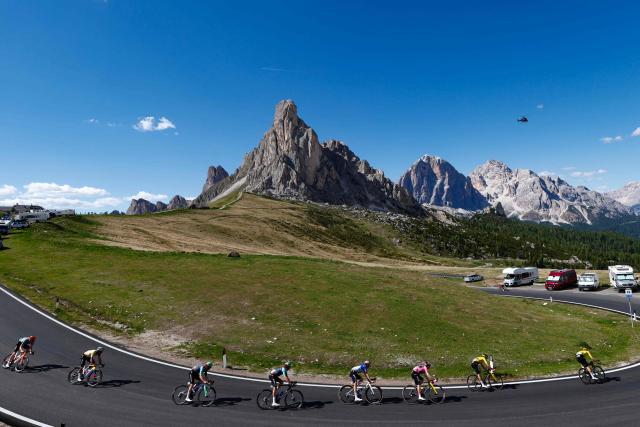 Riders cycle in the descent of Passo Giau during the 19th stage of the Giro d'Italia 2026 - Tour of Italy cycling race between Feltre and Alleghe, Italy, on May 29, 2026. (Photo by Luca Bettini / AFP)