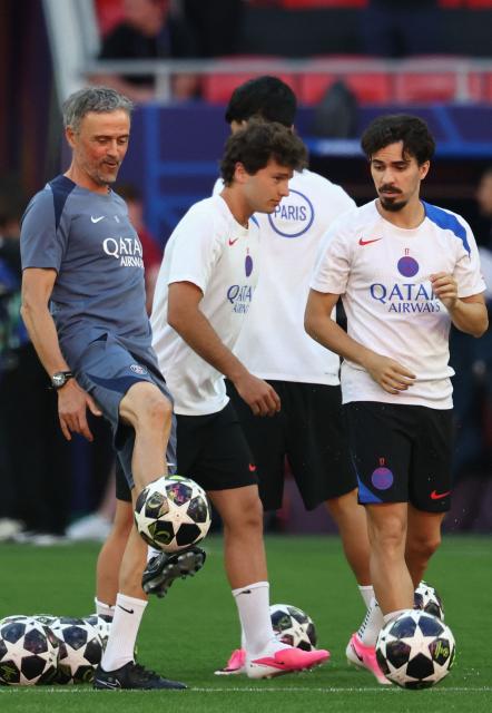 Paris Saint-Germain's Spanish headcoach Luis Enrique (L) controls the ball next to Paris Saint-Germain's Portuguese midfielder #17 Vitinha (R) as he oversees a MD-1 training session of his players on May 29, 2026, the eve of the UEFA Champions League final football match between Paris Saint-Germain (PSG) and Arsenal at the Puskas Arena in Budapest. Paris Saint-Germain (PSG) face Arsenal in the UEFA Champions League final football match on May 30, 2026 in Budapest. (Photo by FRANCK FIFE / AFP)