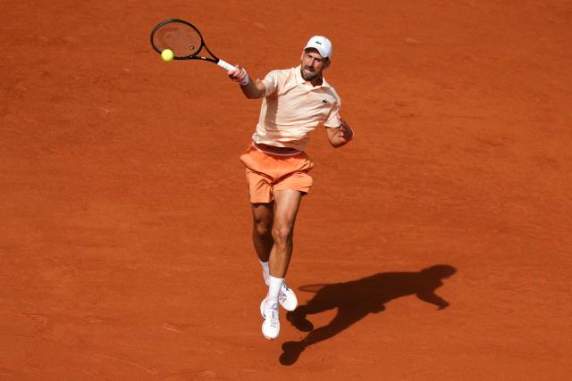 Serbia's Novak Djokovic plays a forehand return to Brazil's Joao Fonseca during their men's singles match on day 6 of the French Open tennis tournament on Court Philippe-Chatrier at the Roland-Garros Complex in Paris on May 29, 2026. (Photo by Dimitar DILKOFF / AFP)