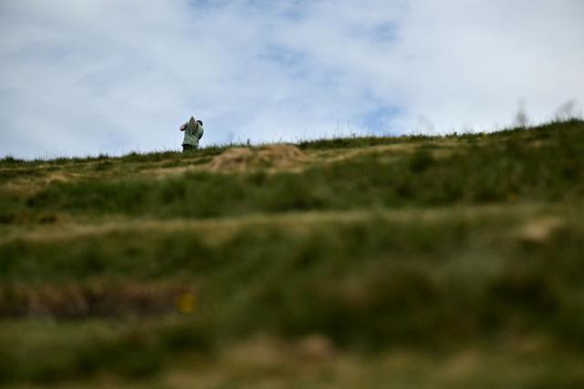 A volunteer carries chalk up the hill during the once-a-decade restoration of the Cerne Abbas Giant, in Dorchester, southern England on May 29, 2026. (Photo by Ben STANSALL / AFP)
