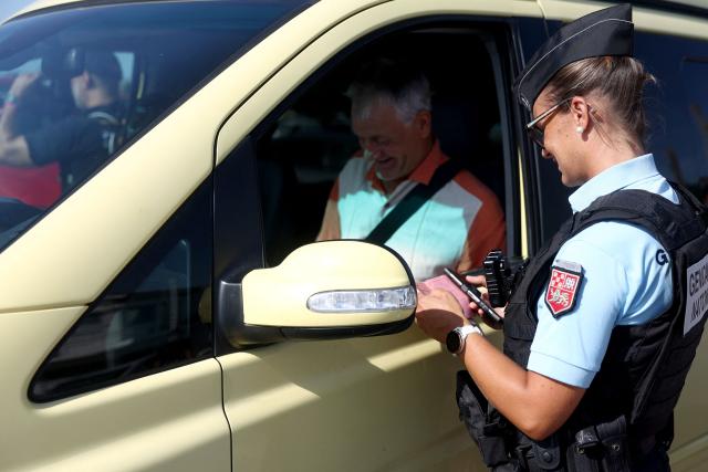 A French Gendarme conducts an ID check on a passenger boarding the ferry "L'Estuaire" connecting Le Verdon-sur-Mer (Gironde) to Royan (Charente-Maritime) during an anti-drug trafficking operation, off the coast of Le Verdon-sur-Mer, south-western France on May 29, 2026. (Photo by ROMAIN PERROCHEAU / AFP)