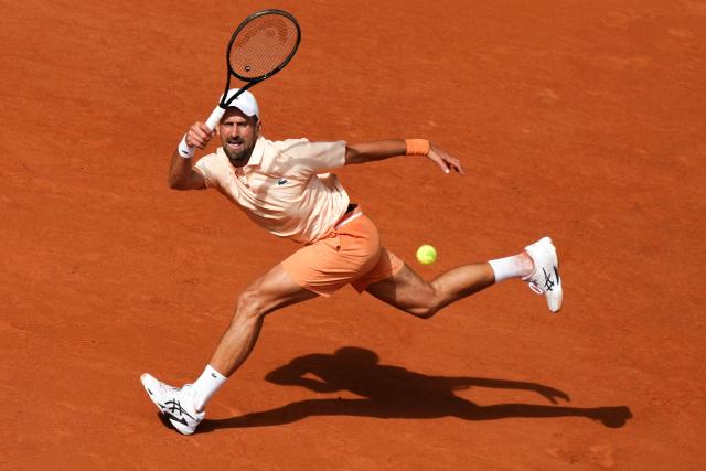TOPSHOT - Serbia's Novak Djokovic plays a forehand return to Brazil's Joao Fonseca during their men's singles match on day 6 of the French Open tennis tournament on Court Philippe-Chatrier at the Roland-Garros Complex in Paris on May 29, 2026. (Photo by Dimitar DILKOFF / AFP)