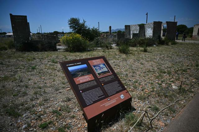 This photograph shows the Rivesaltes Camp Memorial inaugurated in October 2015 and built amidst the remains of the barracks, witnesses to the fate of more than 60,000 people on May 29, 2026 in Rivesaltes, southwestern France. Ten years after it opened, the Rivesaltes Camp Memorial Museum, a site that, throughout the 20th century, housed Spanish refugees, Jews, Roma and Harkis, is revamping its permanent exhibition, aiming to serve as a "bulwark" against tensions surrounding remembrance. (Photo by Lionel BONAVENTURE / AFP)