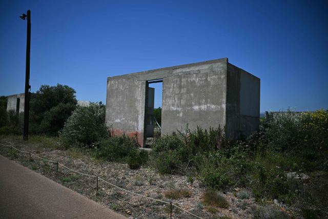 This photograph shows the Rivesaltes Camp Memorial inaugurated in October 2015 and built amidst the remains of the barracks, witnesses to the fate of more than 60,000 people on May 29, 2026 in Rivesaltes, southwestern France. Ten years after it opened, the Rivesaltes Camp Memorial Museum, a site that, throughout the 20th century, housed Spanish refugees, Jews, Roma and Harkis, is revamping its permanent exhibition, aiming to serve as a "bulwark" against tensions surrounding remembrance. (Photo by Lionel BONAVENTURE / AFP)
