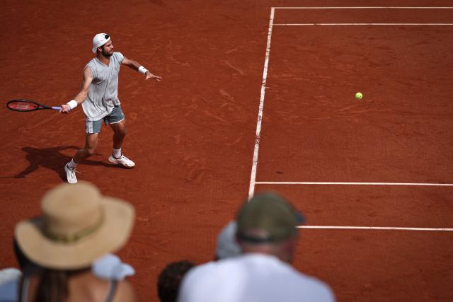 Karen Khachanov plays a forehand return to Netherlands' Jesper de Jong during their men's singles match on day 6 of the French Open tennis tournament at the Roland-Garros Complex in Paris on May 29, 2026. (Photo by Anne-Christine POUJOULAT / AFP)
