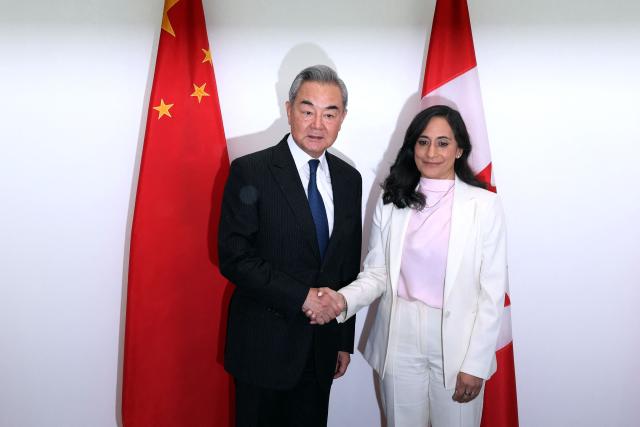 Canada's Minister of Foreign Affairs Anita Anand (R) shakes hands with China's Minister of Foreign Affairs Wang Yi ahead of a bilateral meeting in Ottawa, on May 29, 2026. Wang will be the first Chinese foreign minister to visit Canada since 2016. (Photo by Dave Chan / AFP)
