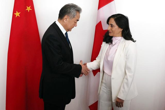 Canada's Minister of Foreign Affairs Anita Anand (R) shakes hands with China's Minister of Foreign Affairs Wang Yi ahead of a bilateral meeting in Ottawa, on May 29, 2026. Wang will be the first Chinese foreign minister to visit Canada since 2016. (Photo by Dave Chan / AFP)