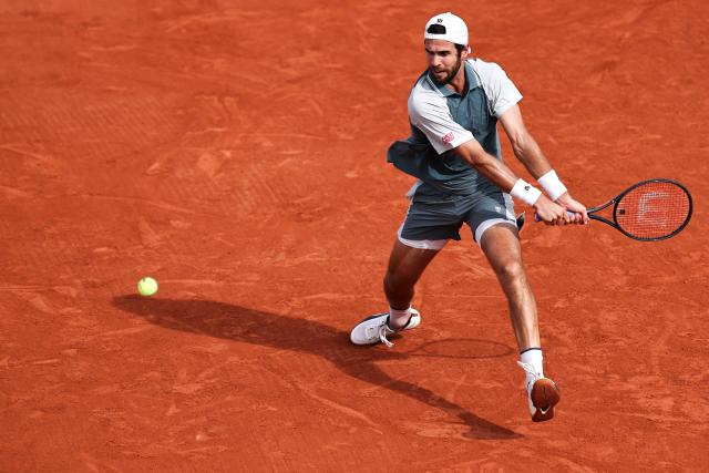 Karen Khachanov plays a backhand return to Netherlands' Jesper de Jong during their men's singles match on day 6 of the French Open tennis tournament at the Roland-Garros Complex in Paris on May 29, 2026. (Photo by Anne-Christine POUJOULAT / AFP)