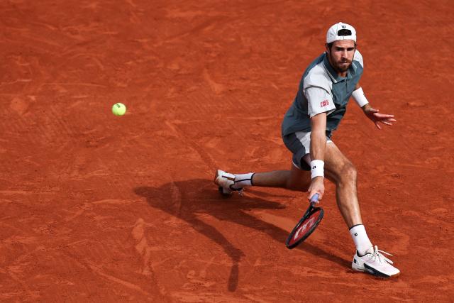 Karen Khachanov plays a backhand return to Netherlands' Jesper de Jong during their men's singles match on day 6 of the French Open tennis tournament at the Roland-Garros Complex in Paris on May 29, 2026. (Photo by Anne-Christine POUJOULAT / AFP)